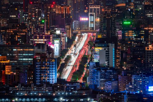 A breathtaking aerial view of Taipei at night showcasing bustling streets and illuminated skyscrapers.