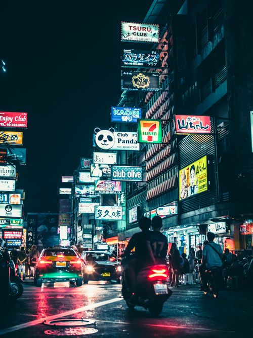 Free Experience the lively urban atmosphere of Bangkok's downtown nightlife filled with bright signs and bustling streets. Stock Photo