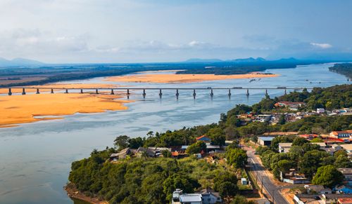 Free Scenic aerial view of a bridge crossing a river in Boa Vista, RR, with lush greenery and clear skies. Stock Photo