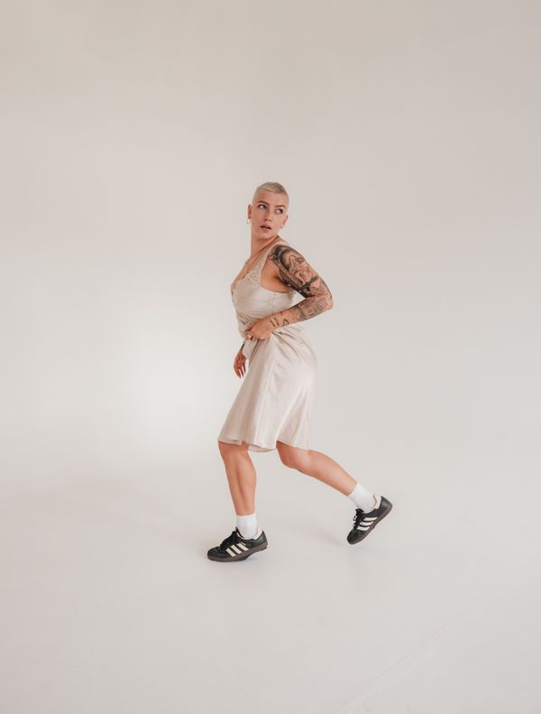 woman wearing slip dress with sneakers casual