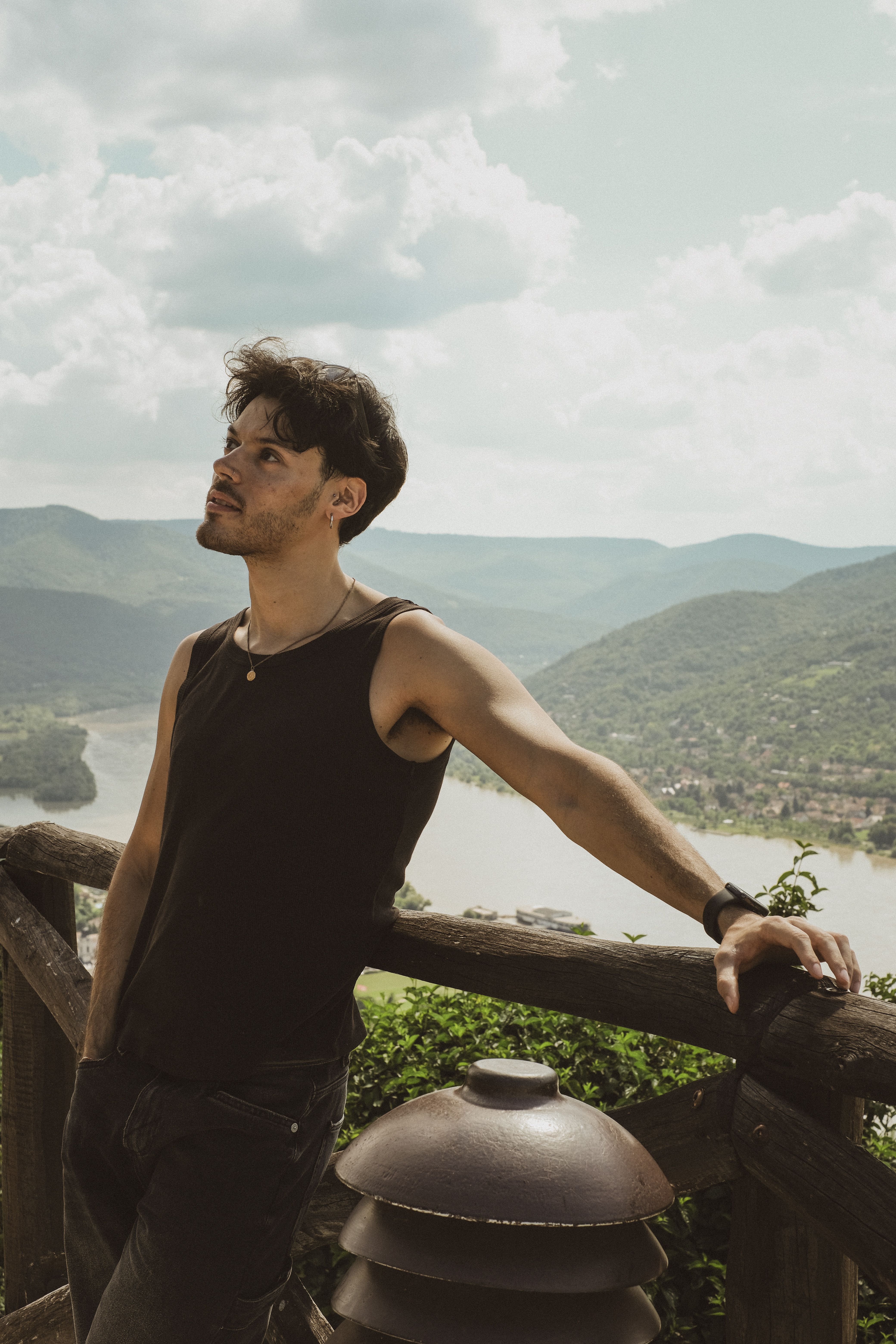 Man in Tank Top Leaning on Railing against Valley · Free Stock Photo