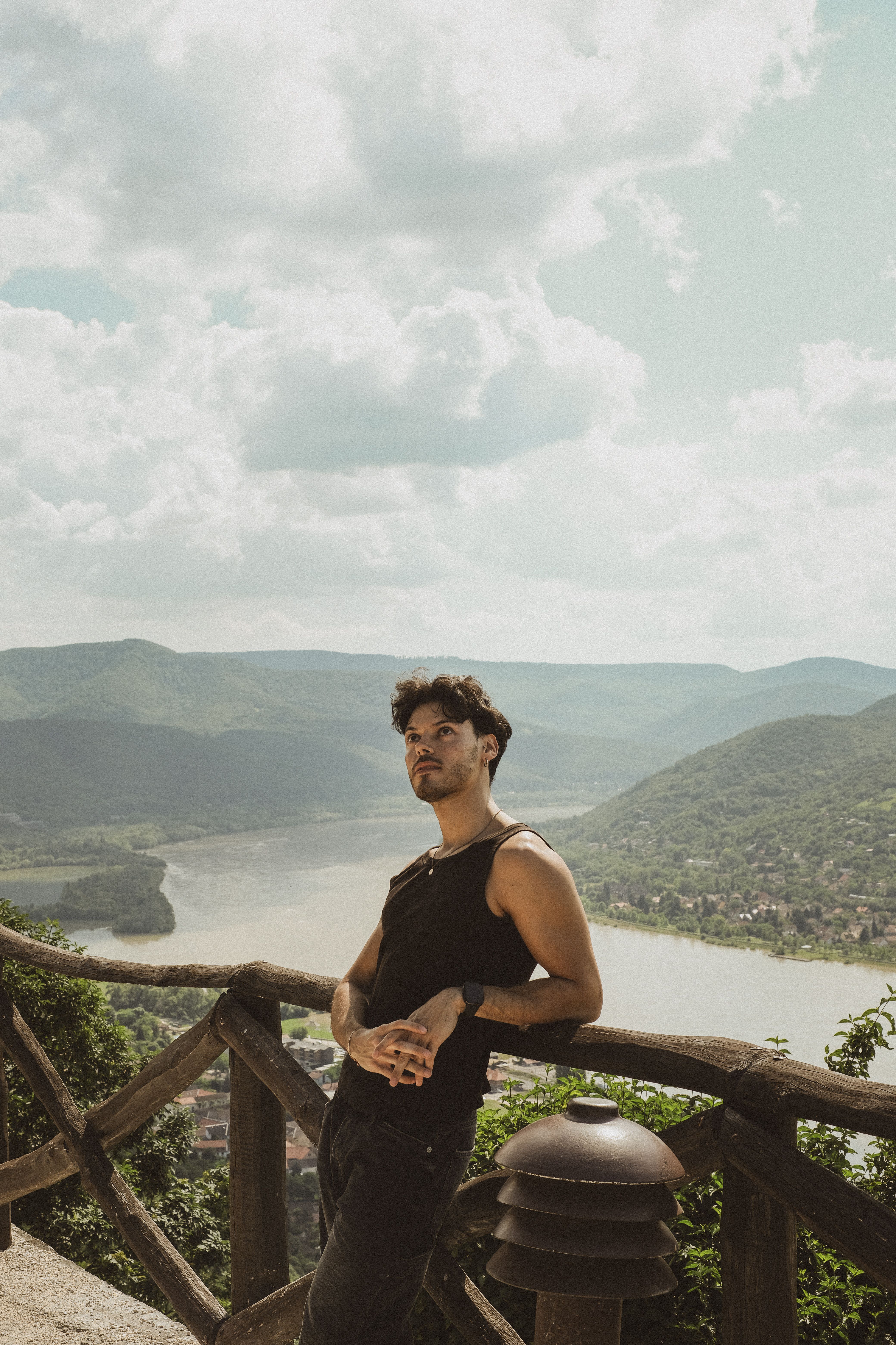 Man Standing and Leaning on Railing in Tank Top · Free Stock Photo