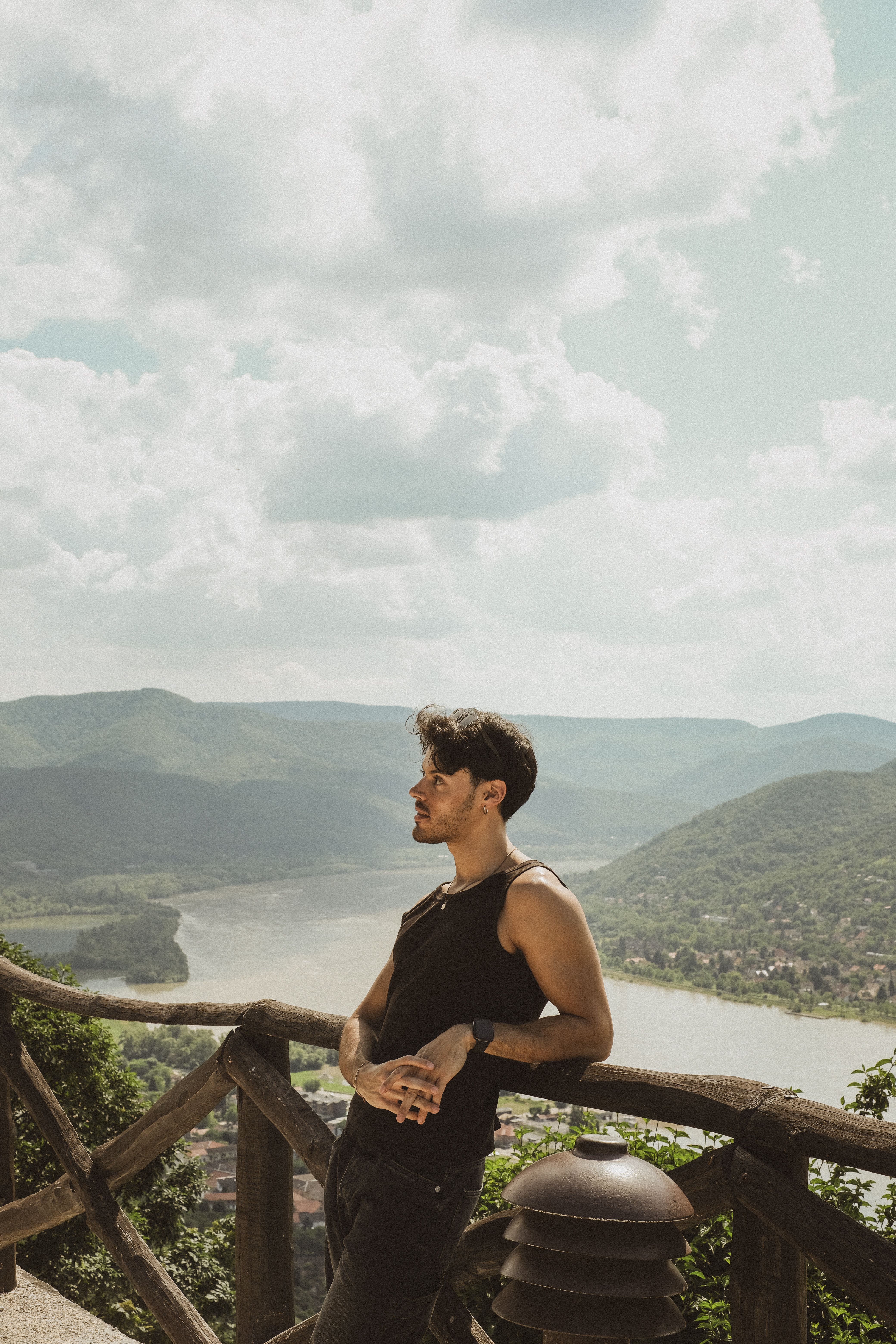 Man Leaning on Railing against Valley with River · Free Stock Photo