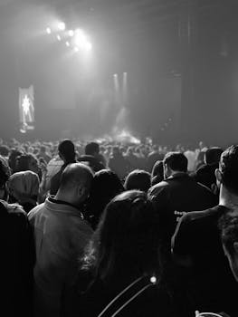 Captivating black and white image of a crowded concert scene at night.