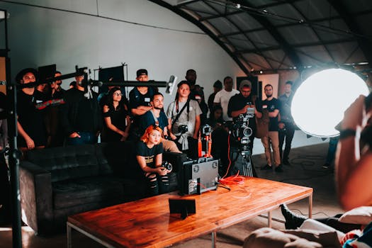 Photographers gathered in a studio for a collaborative photo shoot session.