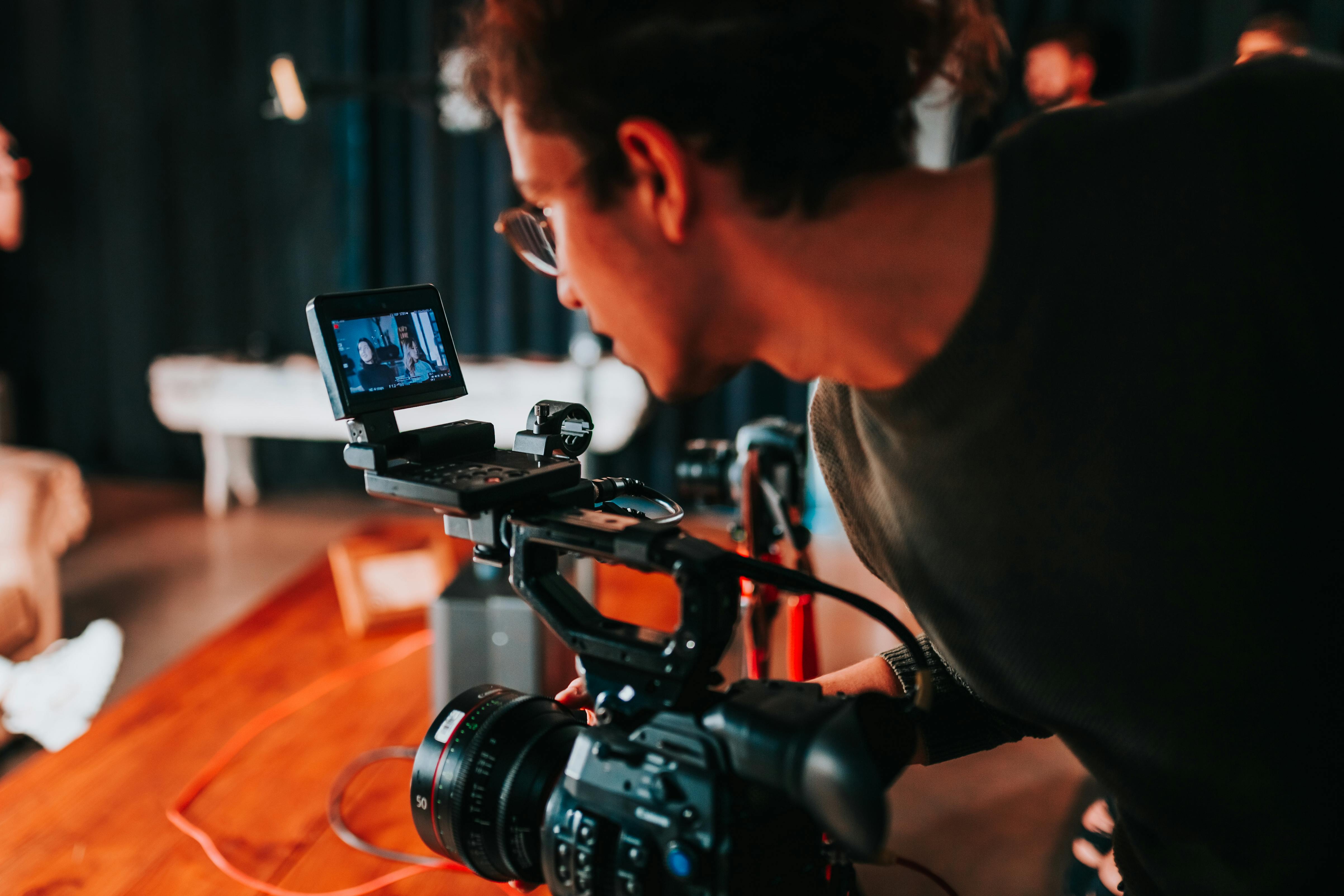 photo of a man holding video camera