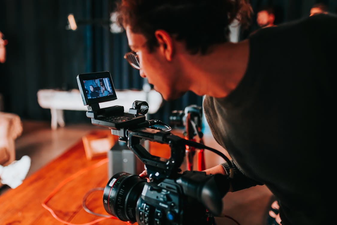 Photo of a Man Holding Video Camera