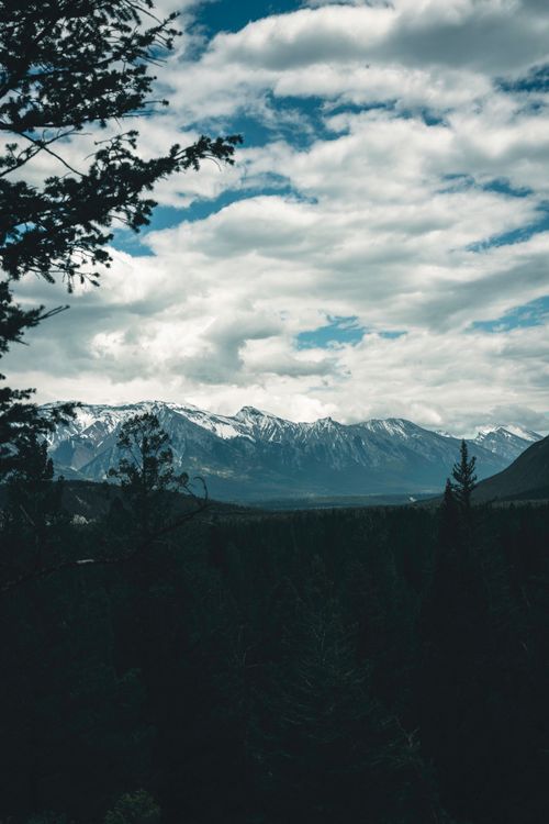 Free Stunning view of snowcapped mountains in Banff National Park, Alberta, Canada, captured on a cloudy day. Stock Photo