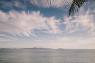 Tranquil ocean scene at Nadi, Fiji with striking clouds and gentle waves.