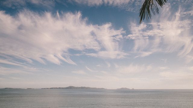 Tranquil ocean scene at Nadi, Fiji with striking clouds and gentle waves. — lounges at Nadi Airport