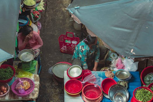 View of a bustling street market with vendors and vibrant produce in Ho Chi Minh City, Vietnam.