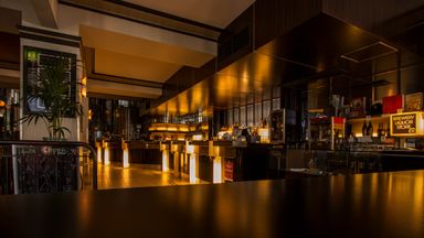 A restaurant dining room in warm low light
