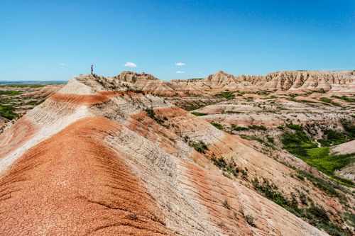 Free A stunning aerial photo showcasing the unique formations of the Badlands under a clear blue sky. Stock Photo