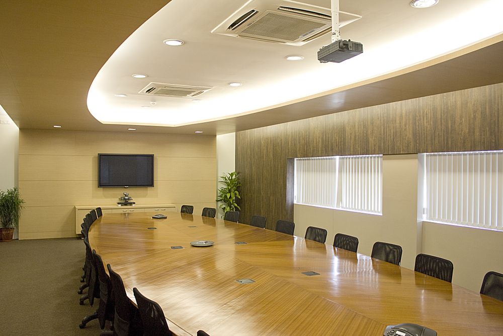 Executives in a boardroom discussing quarterly growth results