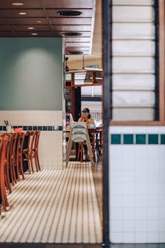 Inviting dining area with wooden chairs and tiled flooring, capturing a cozy restaurant atmosphere.