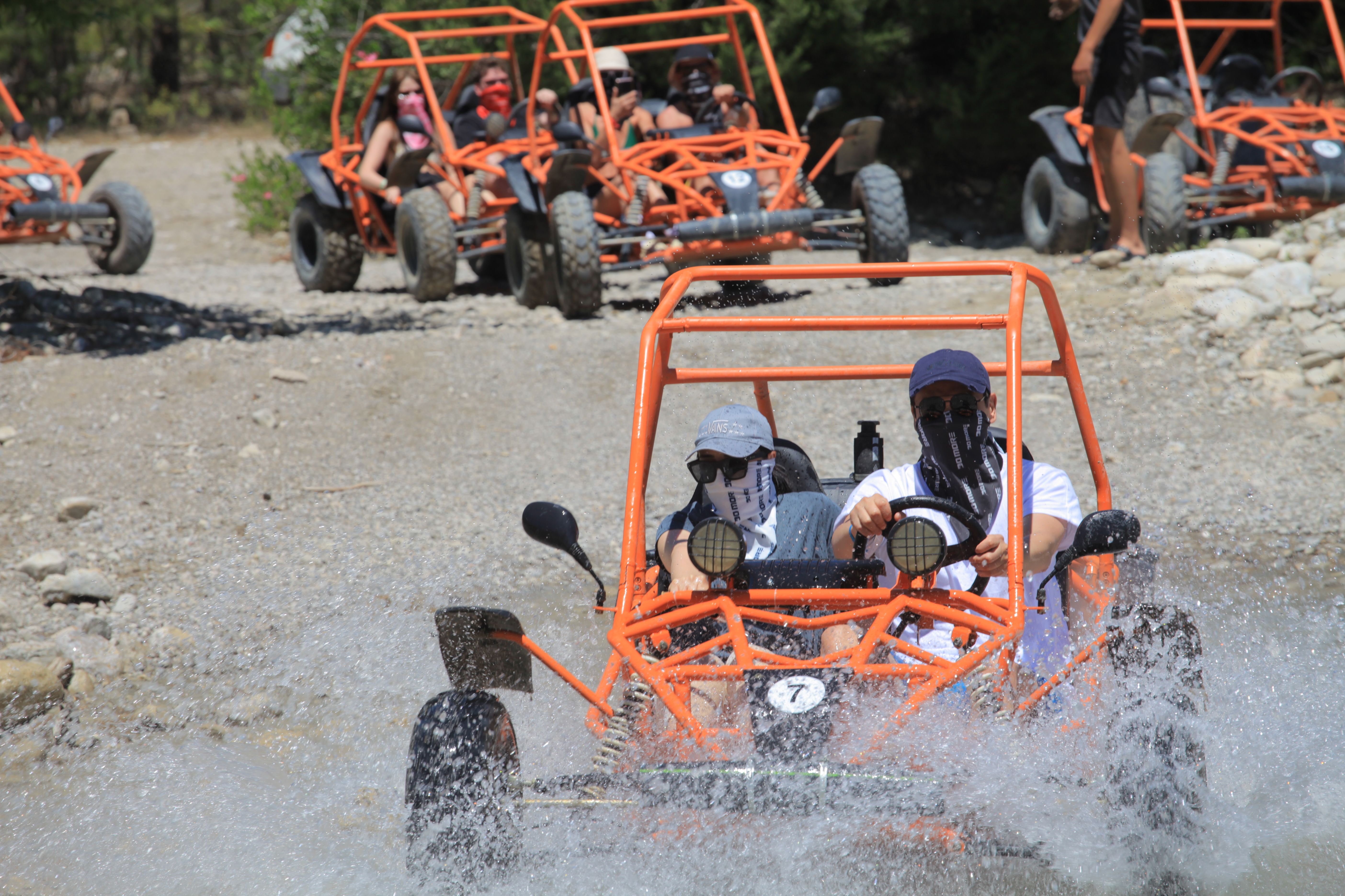 People Riding in Orange Carts · Free Stock Photo