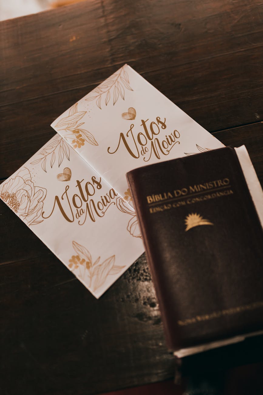 A bible and a wedding invitation on a table