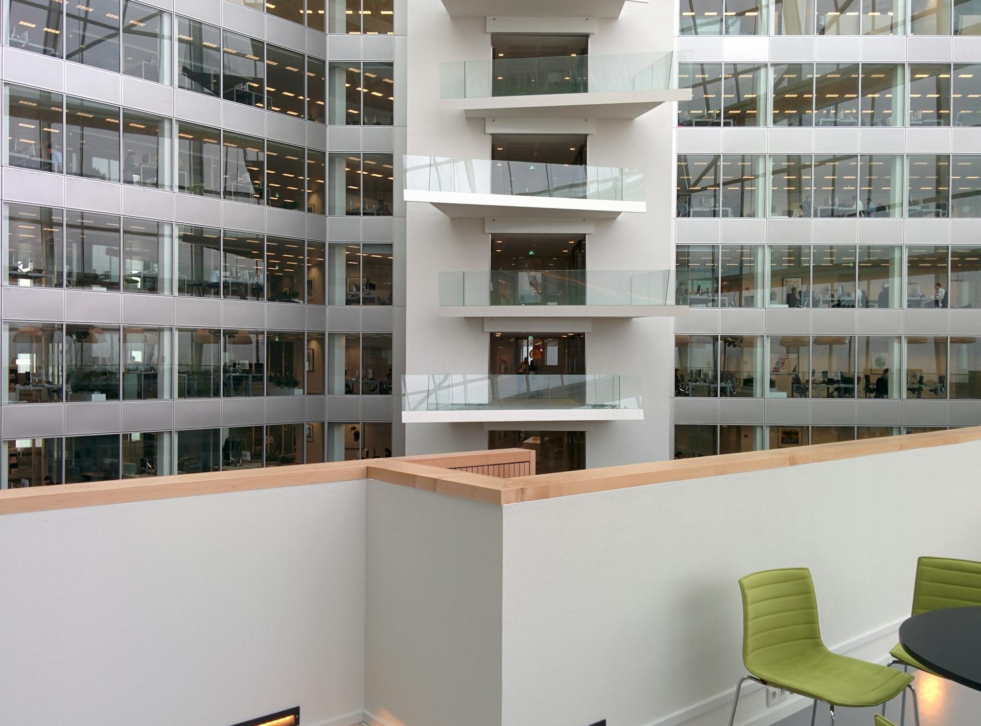 Sleek interior of a modern office building showcasing open balconies and contemporary design.