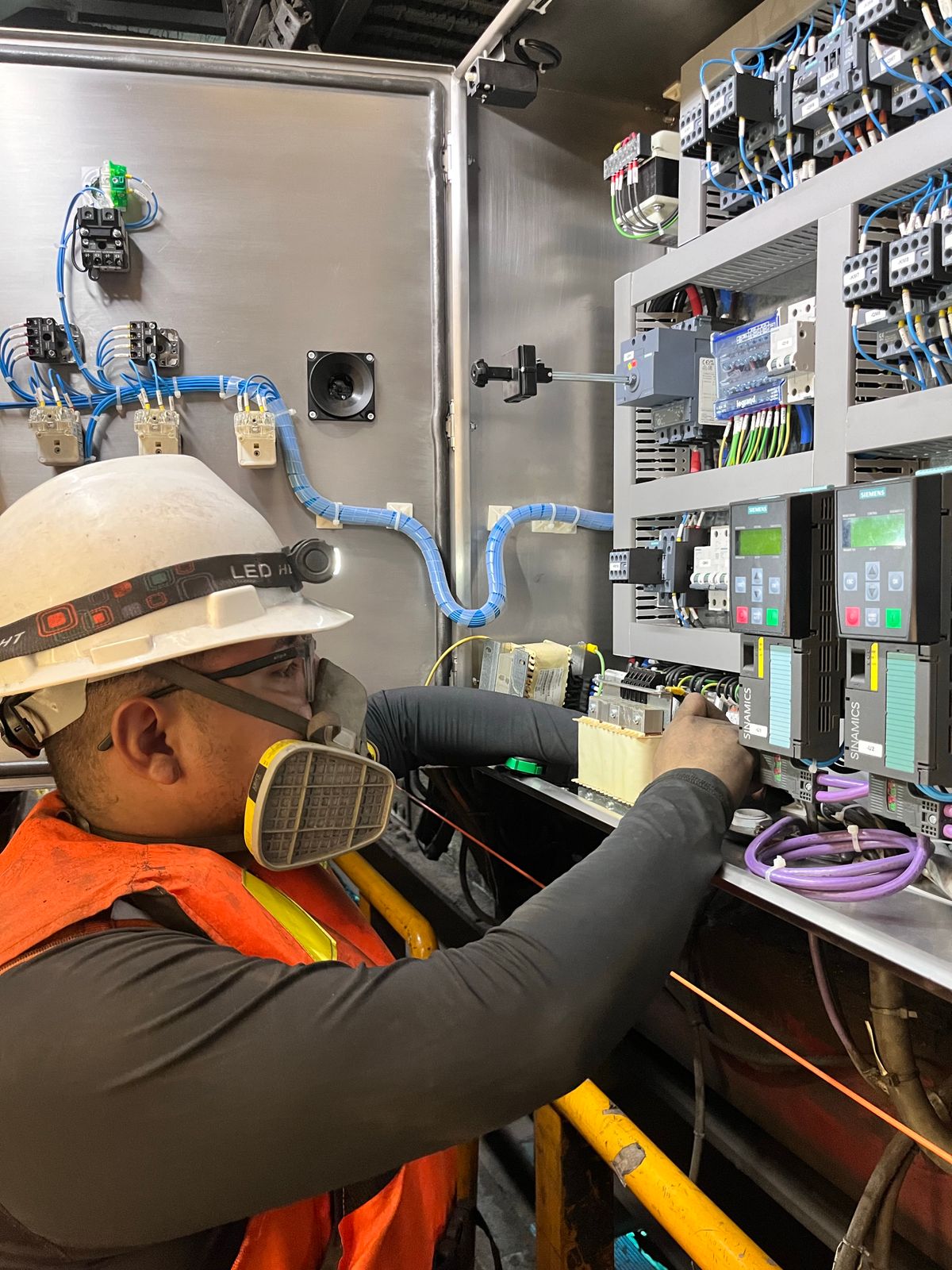 Electrician adjusting wires on a control panel