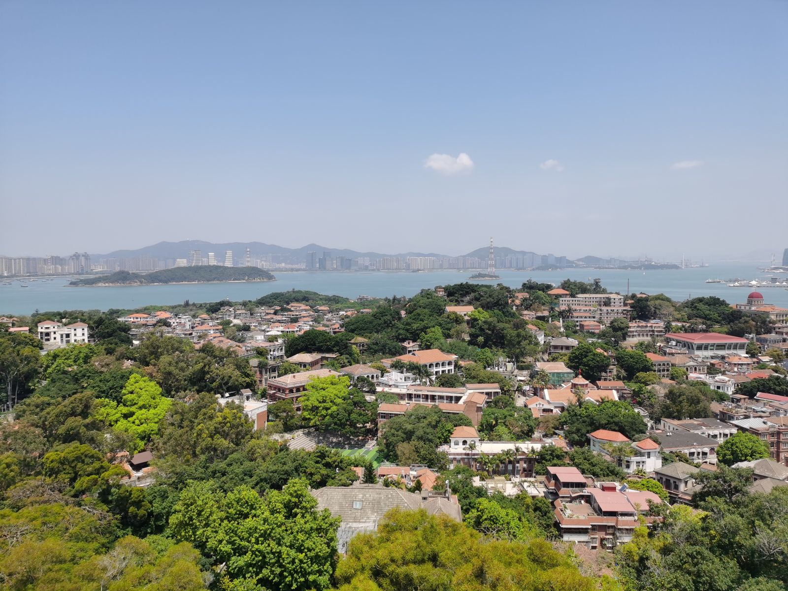 Gulangyu's car-free lanes with the Xiamen skyline across the strait