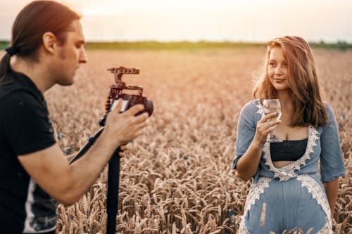Free Photo of a Man Taking Photo of a Woman  Stock Photo