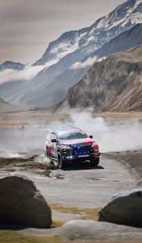 Explore thrilling off-road driving in a rugged mountain landscape with this powerful SUV kicking up dust.