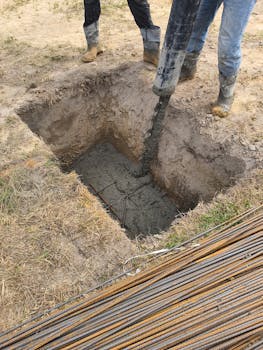 A detailed view of concrete pouring at a construction site in Miedniewice-Topola, Poland.