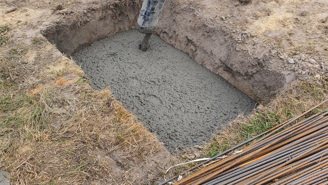 A slab pour under way. Everything below that concrete is fixed for the life of the house.