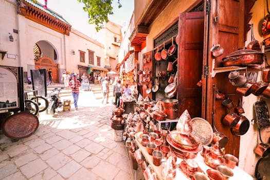 A bustling Moroccan street market showcasing copper goods in a vibrant medina setting.