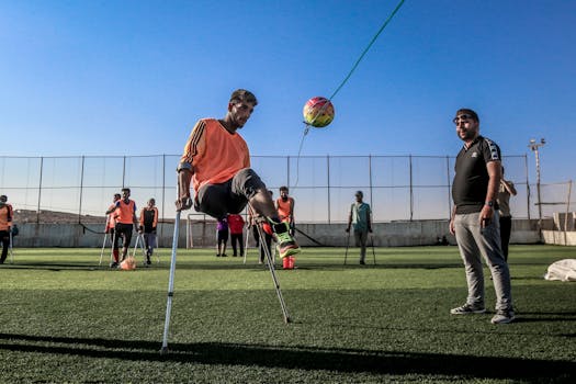 A group of amputee soccer players train with a ball on a sunny day in Syria.