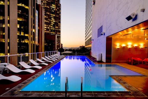 Free White Sunloungers Beside Pool Stock Photo