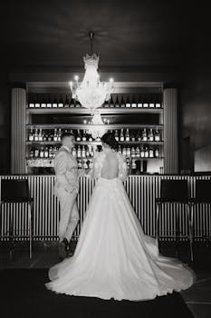 A bridal couple enjoying a moment at an elegant bar setting.