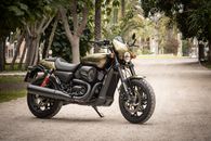 Photo of Black and Brown Harley Davidson 750 Parked on Gravel Road