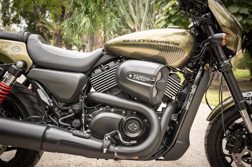 Close-up Photo of Black and Brown Harley Davidson 750 Parked on Gravel Road