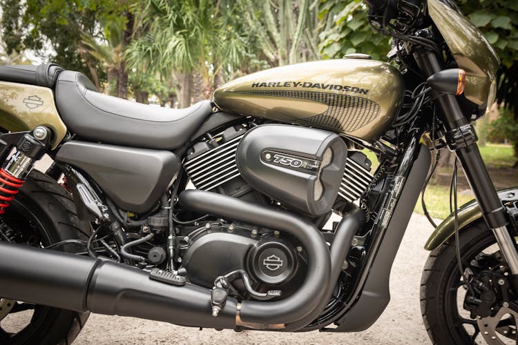 Close-up Photo Of Black And Brown Harley Davidson 750 Parked On Gravel Road