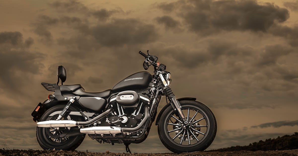 Harley Davidson motorcycle parked outdoors against a dramatic sunset sky, showcasing elegance and freedom.
