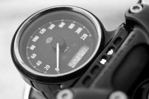 Close-up Photo of Black and Chrome Analog Motorcycle Speedometer
