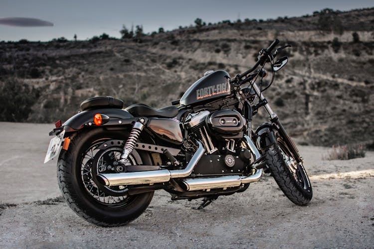 Photo Of Black Harley Davidson Forty-Eight 1200 Motorcycle Parked On Gravel Road