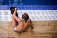 Boy Sitting Near Swimming Pool