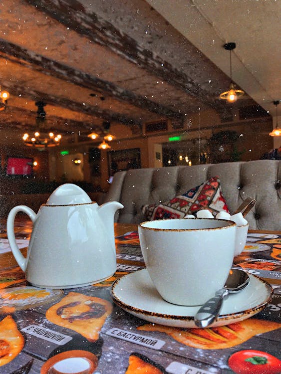 Free Photo of White Ceramic Cup and Pot on Table Stock Photo