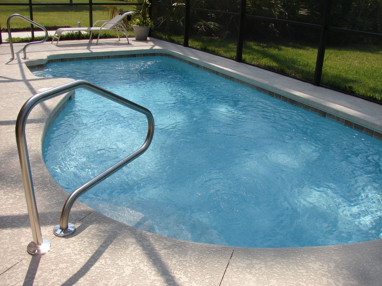 Clean, well-maintained residential swimming pool with handra — Boutique Clothing Store Website Design Ocala | DAS — Ocala, FL