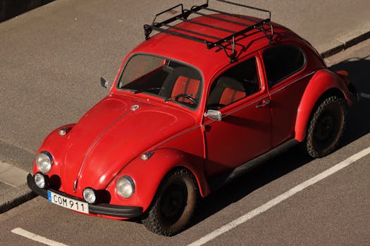 Classic red Volkswagen Beetle parked on a street in Jönköping, Sweden. Ideal for automotive enthusiasts.