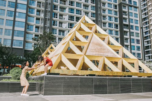 Free Women Playing on Triangular Structure Stock Photo