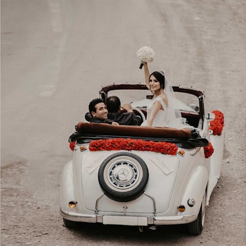 Groom And Bride Riding On White Vehicle