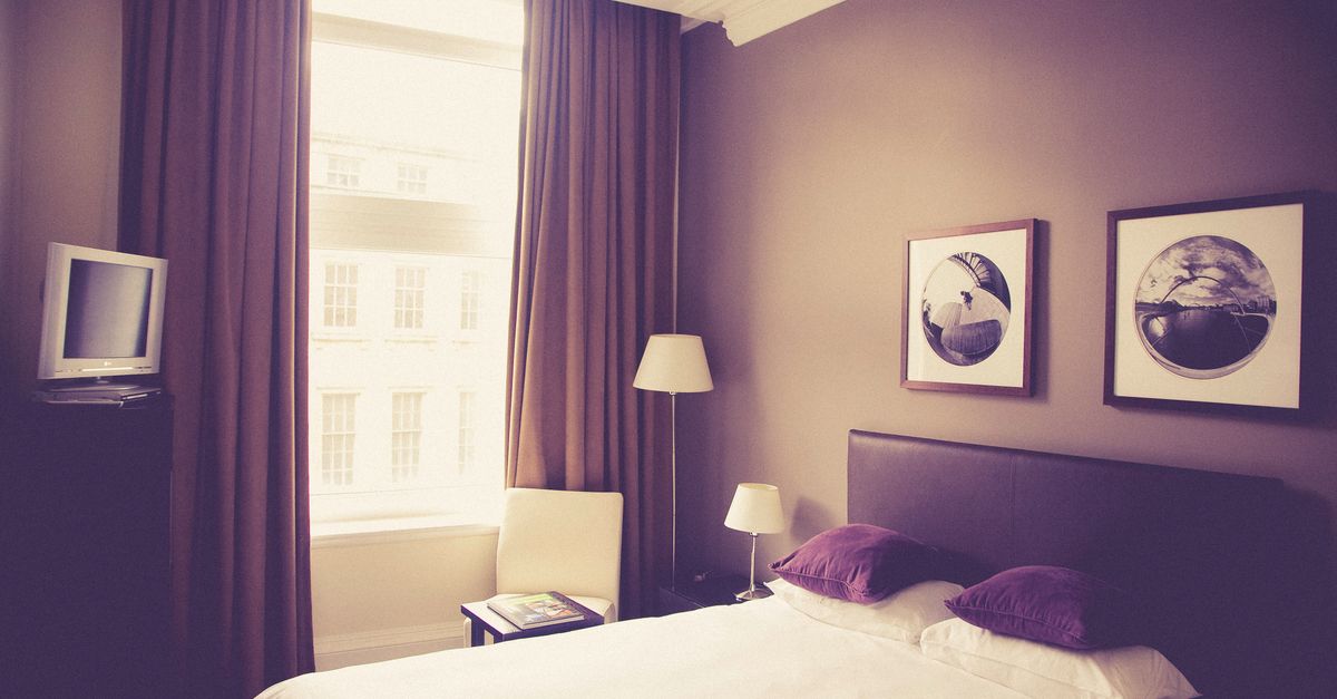 minimalist bedroom, no devices, book on nightstand, soft natural light