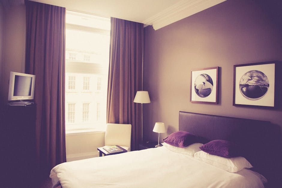 White Bed Pillow on White Bed Comforter in Brown Room