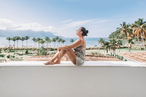 Tourist Posing in the Holiday Resort by a Tropical Beach