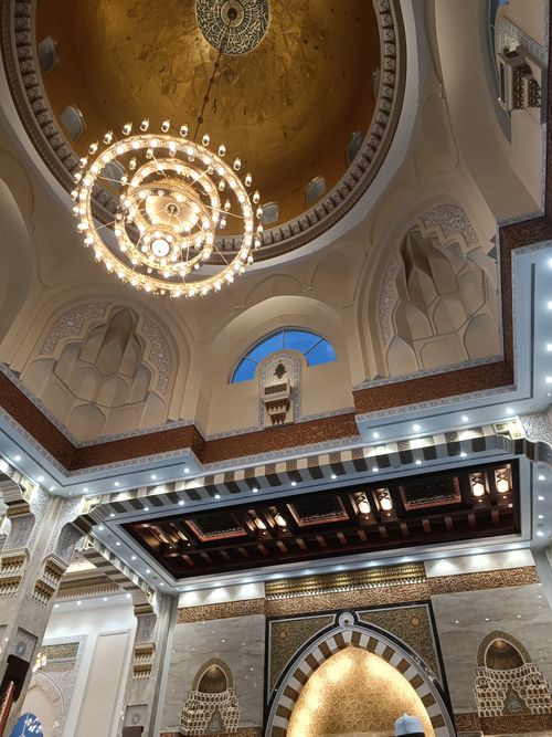 Free Captivating interior view of Sri Sendayan Mosque featuring an elegant chandelier and Islamic architecture. Stock Photo