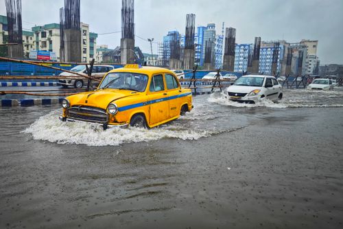 Free A yellow taxi battles flooding on urban streets in Kolkata, India. Heavy rain impacts city traffic. Stock Photo
