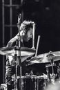 Grayscale Photo of a man playing drums